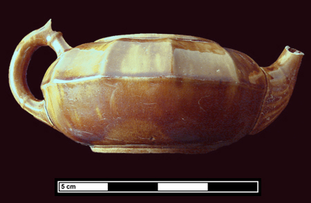 Federal Reserve Site - Panel molded teapot, Rockingham glaze on buff-bodied earthenware, shows side and top view.